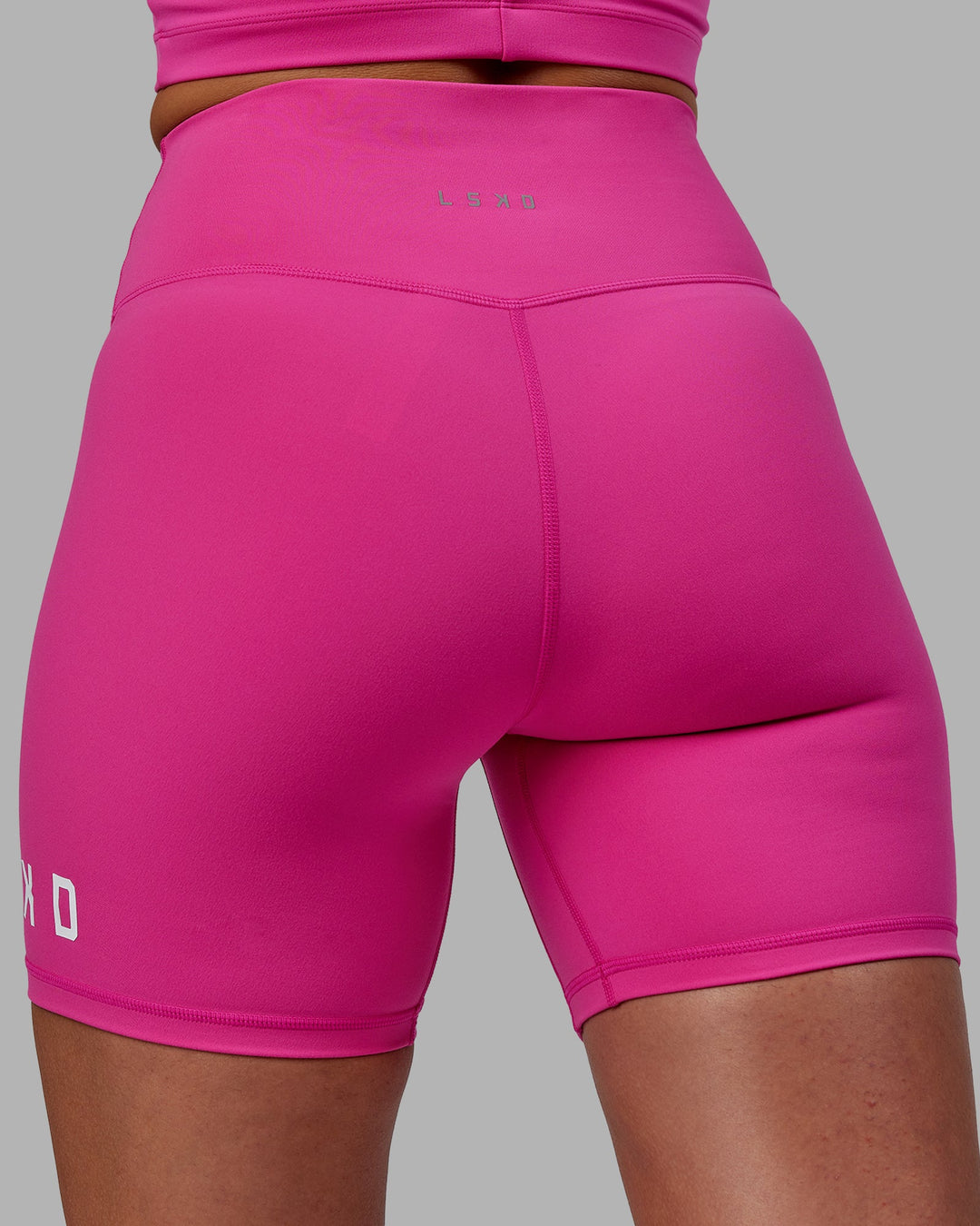 Woman wearing Evolved Mid Short Tights - Fuchsia Pink-White