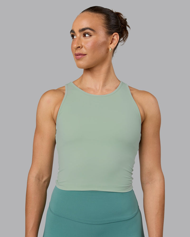 Woman wearing Flow Shelf Bra Performance Tank - Surf Spray
