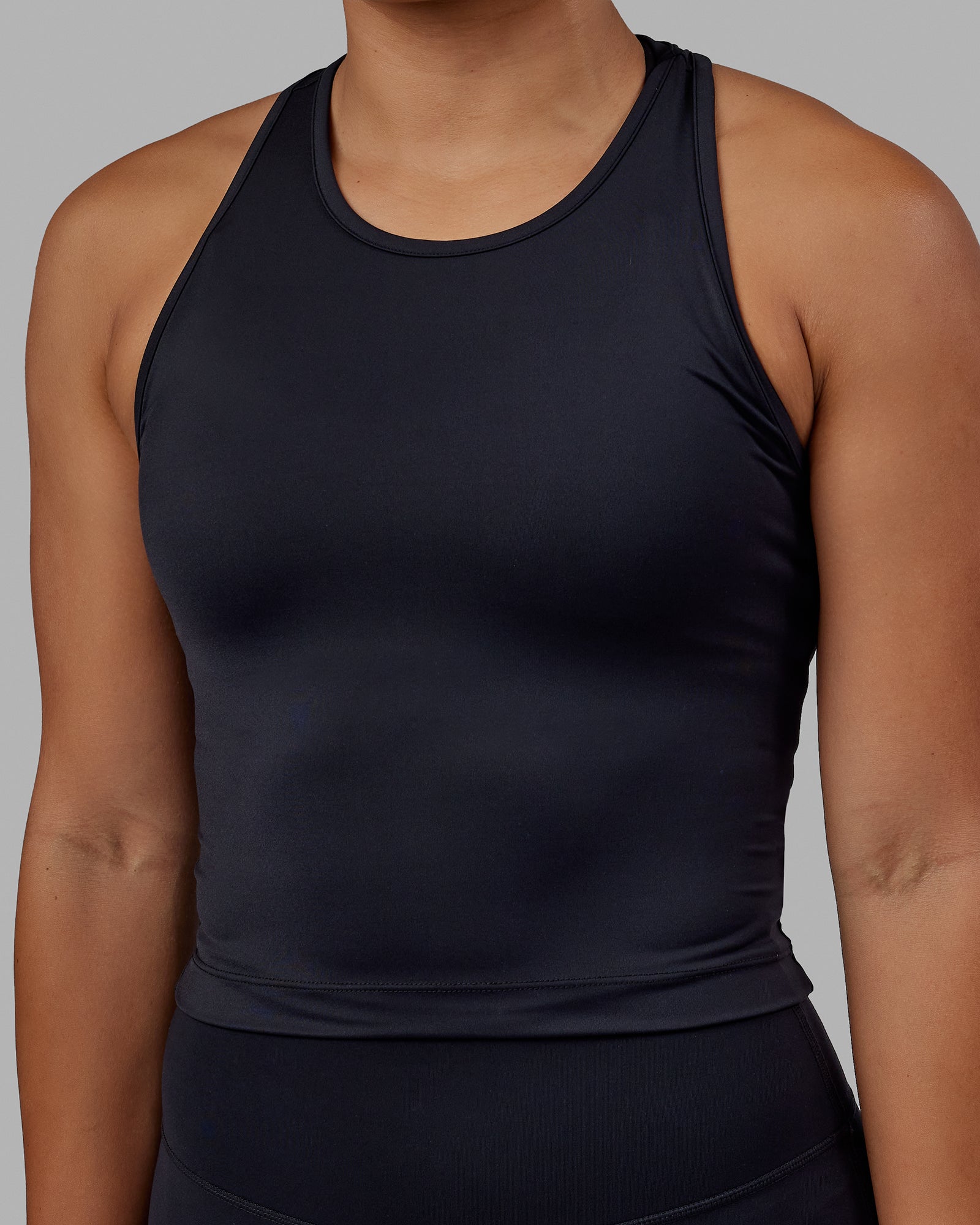 Woman wearing Flow Performance Tank - Black | Model:Xantheia | Size:S