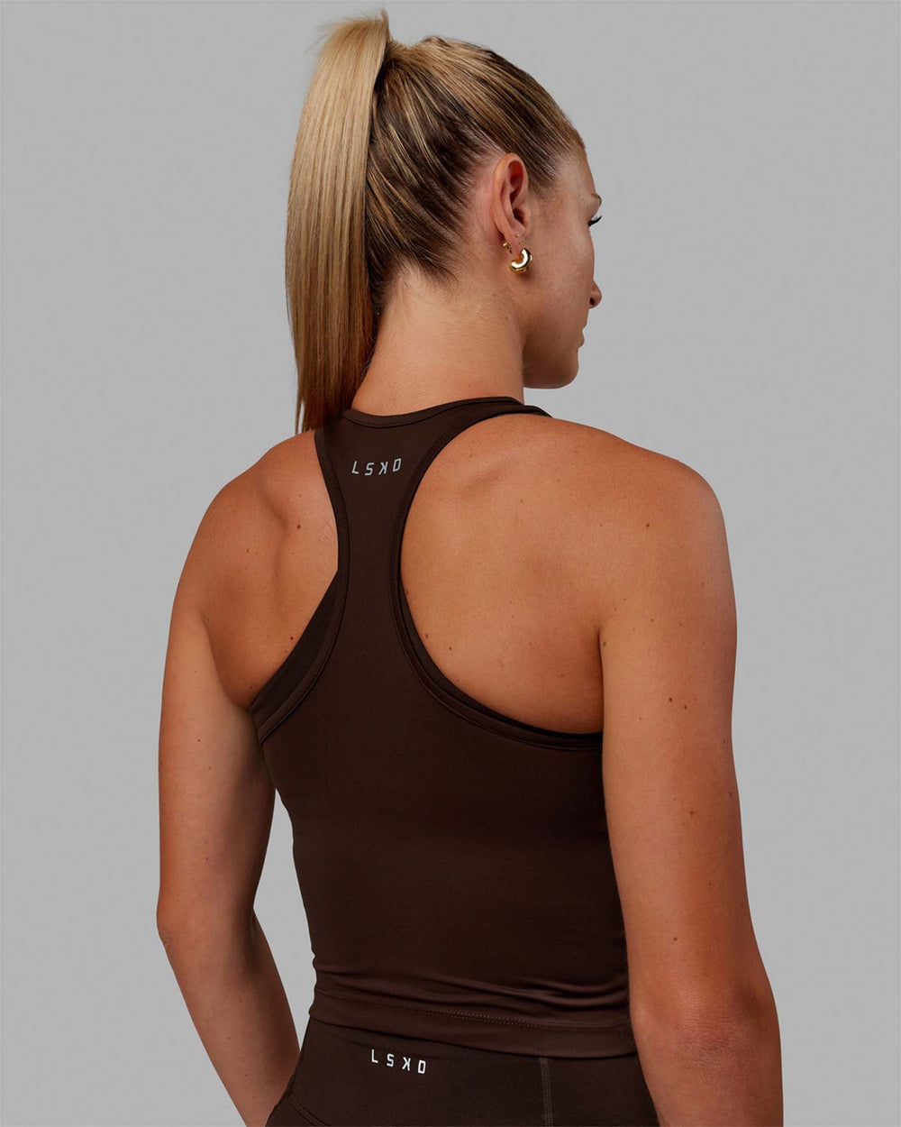 Woman wearing Flow Racerback Tank - Dark Chocolate