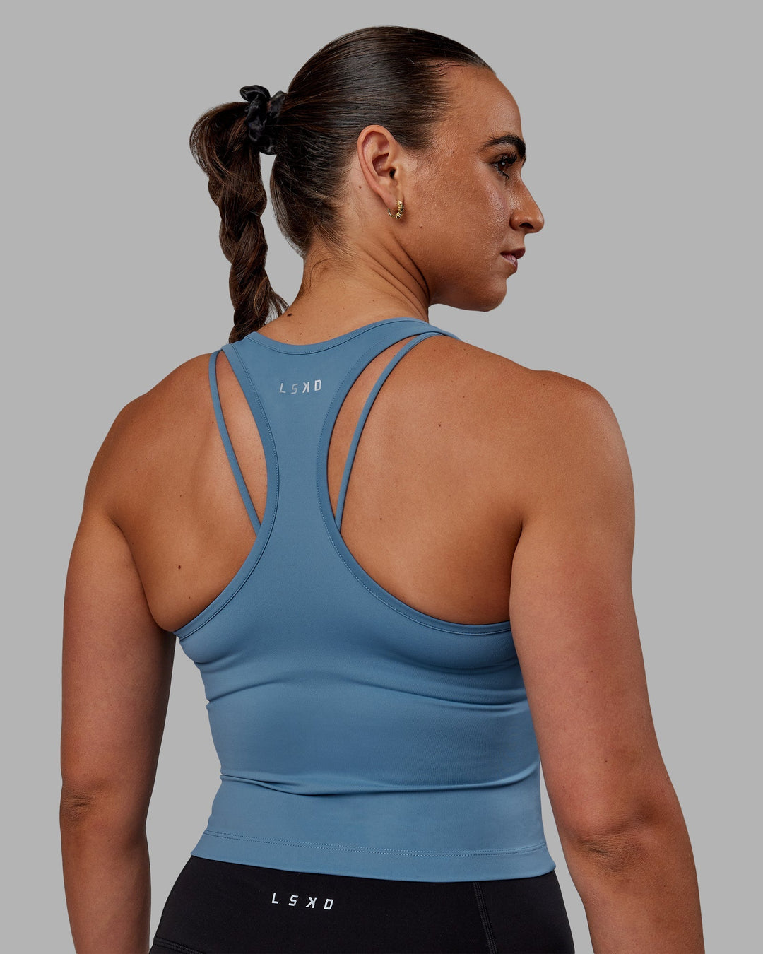 Woman wearing Flow Performance Tank - Elemental Blue