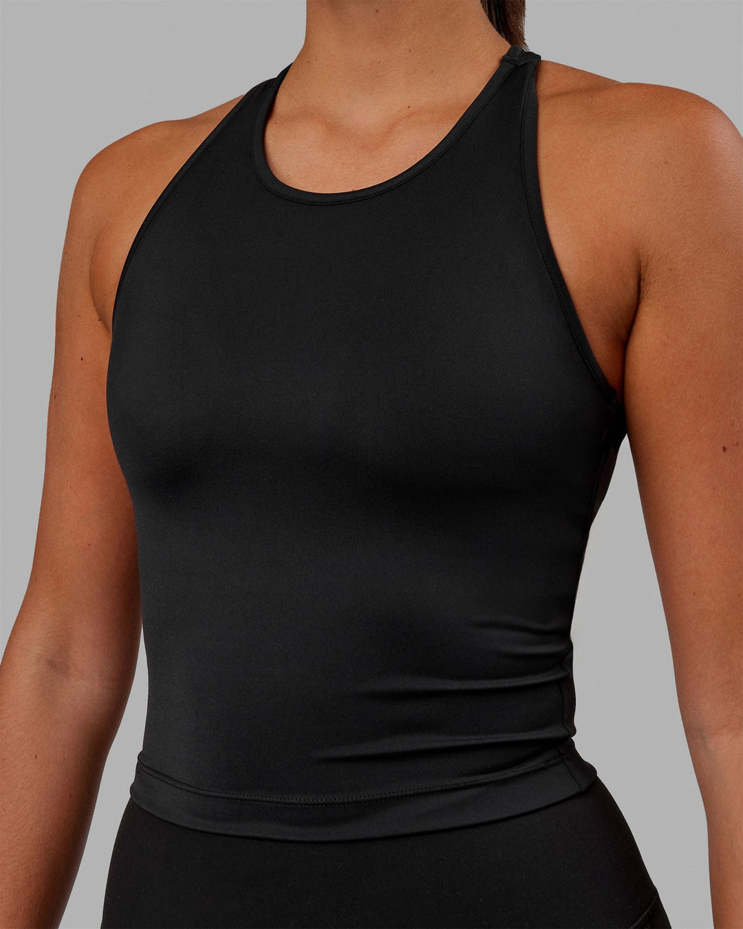 Woman wearing Flow Shelf Bra Performance Tank - Black