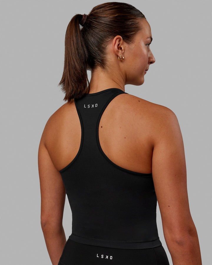 Woman wearing Flow Shelf Bra Performance Tank - Black
