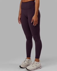 Woman wearing Fusion Ultra High-Rise Full Length Legging Pockets - Midnight Plum | Model:Gabby | Size:S
