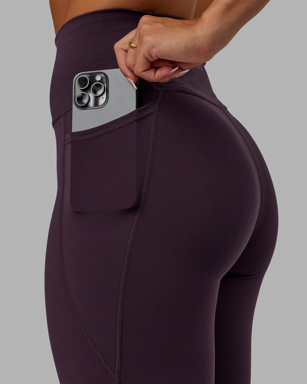 Woman wearing Fusion Ultra High-Rise Full Length Legging Pockets - Midnight Plum | Model:Gabby | Size:S