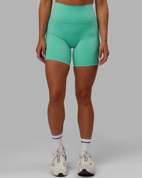 Woman wearing Fusion Ultra High-Rise 6" Short Pockets - Aquatic Awe | Model:Gabby | Size:S