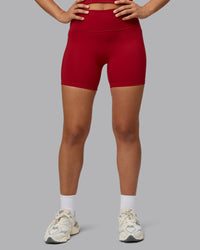 Woman wearing Fusion Ultra High-Rise 6" Short Pockets - Cherry Red | Model:Sophie | Size:S