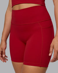 Woman wearing Fusion Ultra High-Rise 6" Short Pockets - Cherry Red | Model:Sophie | Size:S