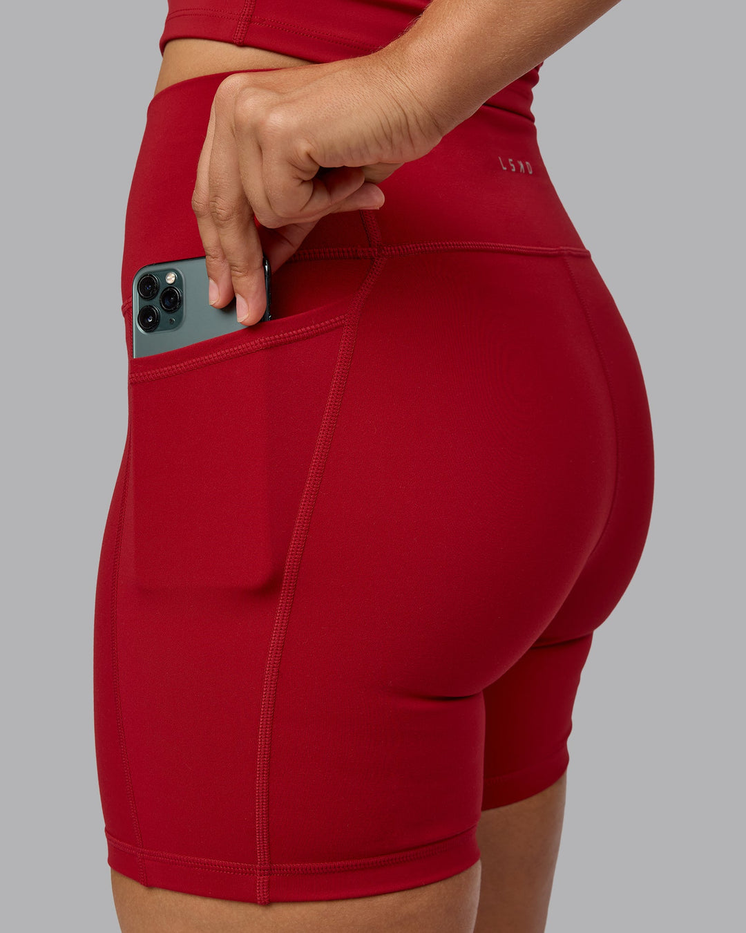 Woman wearing Fusion Mid Short Tights with Pockets - Cherry Red