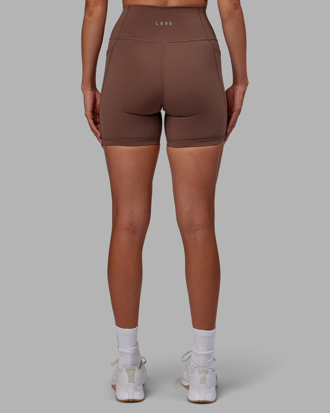 Woman wearing Fusion Mid-Length Shorts - Dull Rust