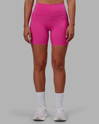 Woman wearing Fusion Ultra High-Rise 6" Short Pockets - Fuchsia Pink | Set:true | Angle:front | Model:Sophie | Size:S