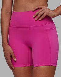 Woman wearing Fusion Ultra High-Rise 6" Short Pockets - Fuchsia Pink | Model:Sophie | Size:S