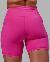 Woman wearing Fusion Ultra High-Rise 6" Short Pockets - Fuchsia Pink | Model:Sophie | Size:S