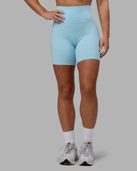 Woman wearing Fusion Ultra High-Rise 6" Short Pockets - Glacial Blue | Set:true | Angle:front | Model:Monique | Size:S