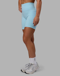 Woman wearing Fusion Ultra High-Rise 6" Short Pockets - Glacial Blue | Set:true | Angle:side | Model:Monique | Size:S