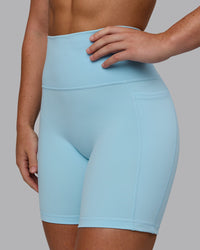 Woman wearing Fusion Ultra High-Rise 6" Short Pockets - Glacial Blue | Model:Monique | Size:S