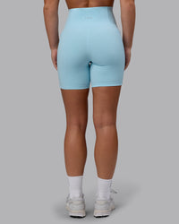Woman wearing Fusion Ultra High-Rise 6" Short Pockets - Glacial Blue | Set:true | Angle:back | Model:Monique | Size:S