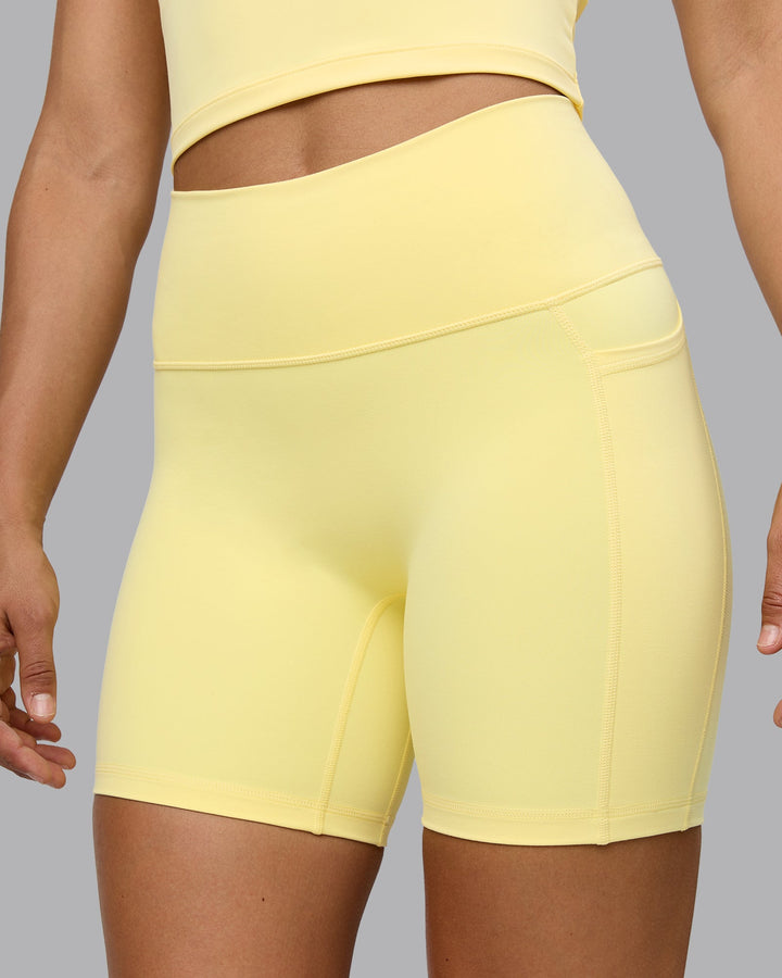 Woman wearing Fusion Mid Short Tights with Pockets - Lemon
