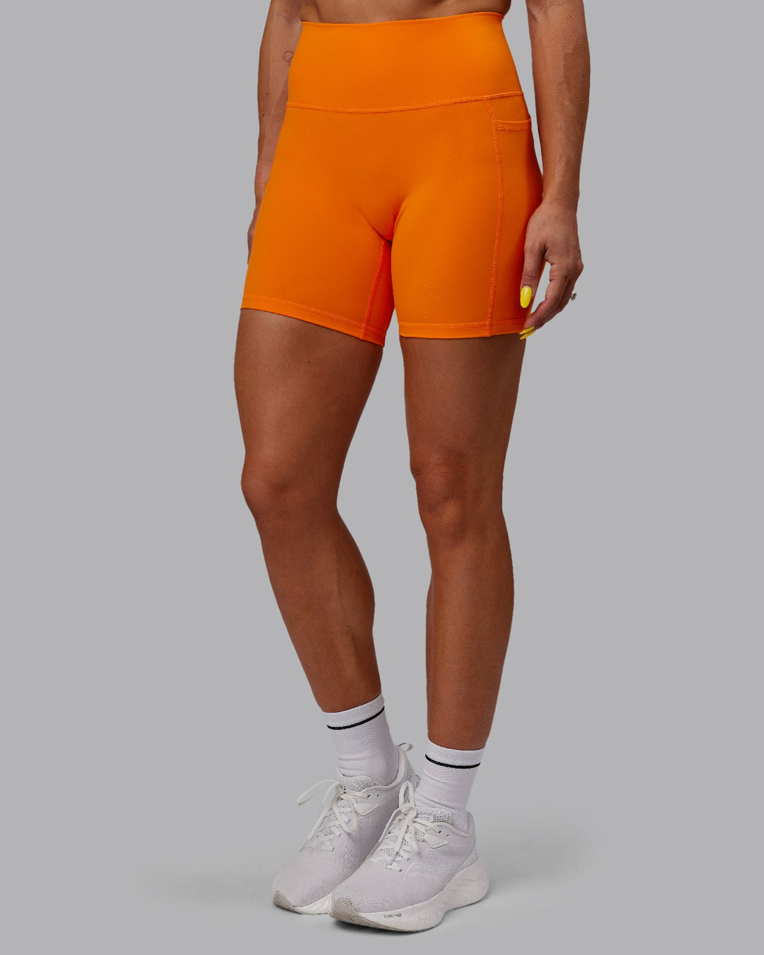 Woman wearing Fusion Mid-Length Shorts - Vibrant Orange