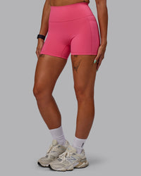 Woman wearing Fusion Ultra High-Rise 4" Short Pockets - Hot Pink | Set:true | Angle:side | Model:Vanessa | Size:S