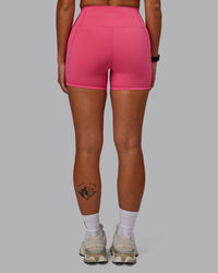 Woman wearing Fusion Ultra High-Rise 4" Short Pockets - Hot Pink | Set:true | Angle:back | Model:Vanessa | Size:S