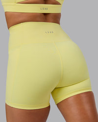 Woman wearing Fusion Ultra High-Rise 4" Short Pockets - Lemon Fizz | Model:Shalem | Size:S | Thumbnail Index: 6