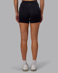 Woman wearing Fusion Ultra High-Rise 4" Short - Black | Set:true | Angle:back | Model:Hannah | Size:S