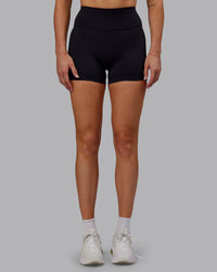 Woman wearing Fusion Ultra High-Rise 4" Short - Black | Set:true | Angle:front | Model:Hannah | Size:S