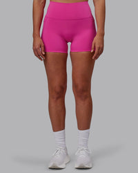 Woman wearing Fusion Ultra High-Rise 4" Short Pockets - Fuchsia Pink | Set:true | Angle:front | Model:Sophie | Size:S