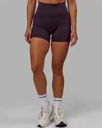 Woman wearing Fusion Ultra High-Rise 4" Short Pockets - Midnight Plum | Model:Gabby | Size:S