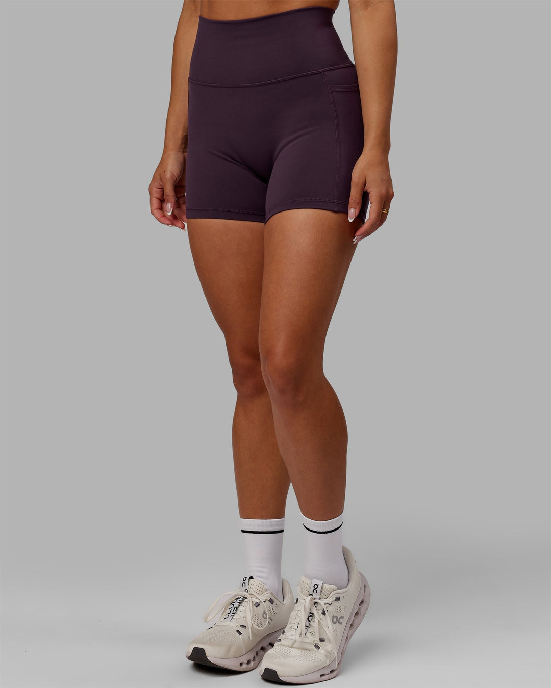 Woman wearing Fusion Ultra High-Rise 4" Short Pockets - Midnight Plum | Model:Gabby | Size:S
