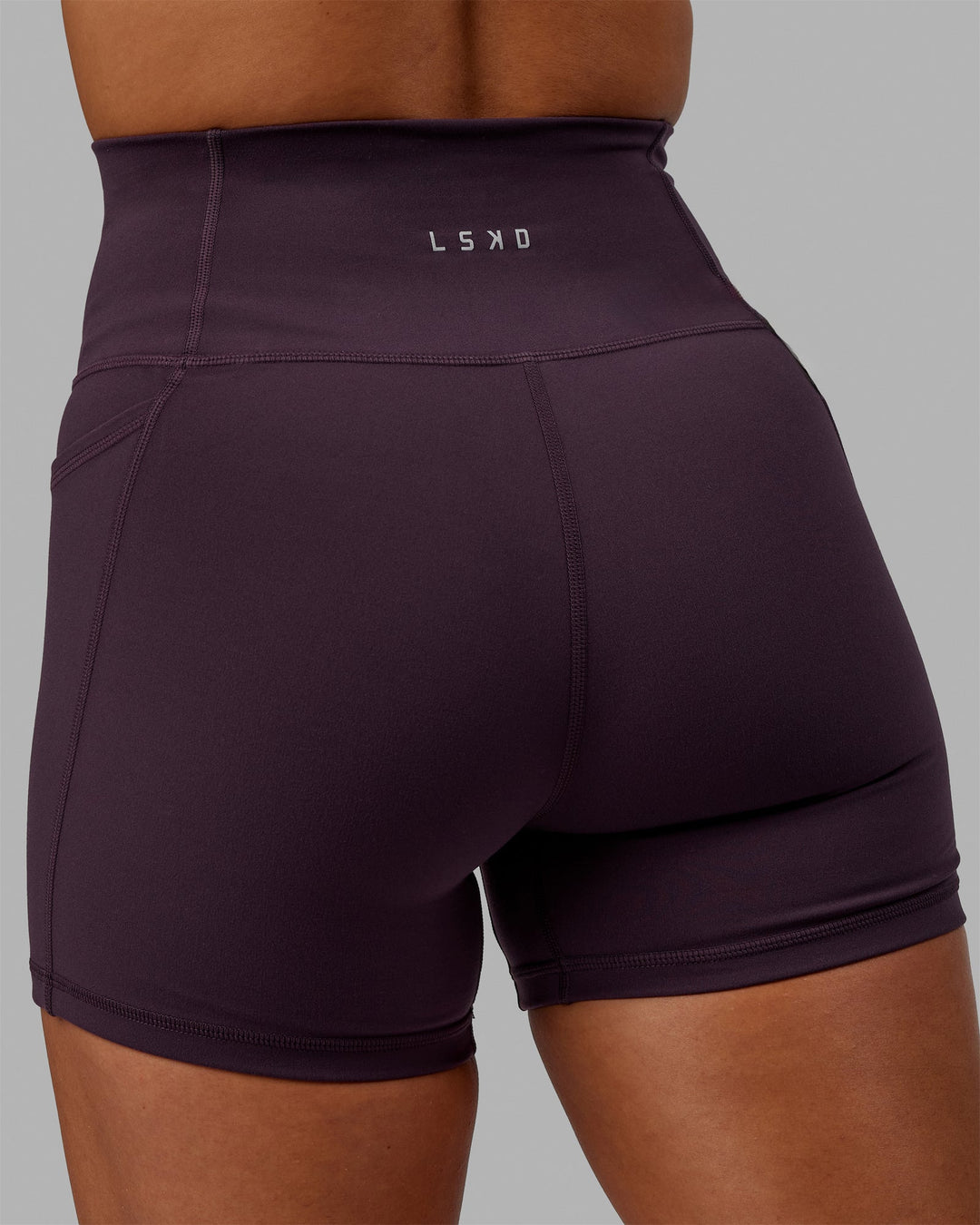 Woman wearing Fusion Ultra High-Rise 4" Short Pockets - Midnight Plum | Model:Gabby | Size:S
