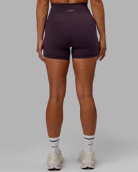 Woman wearing Fusion Ultra High-Rise 4" Short Pockets - Midnight Plum | Model:Gabby | Size:S