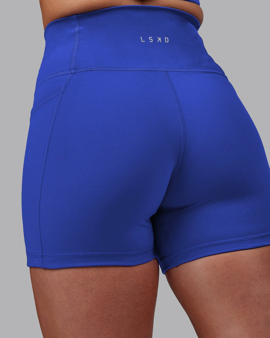 Woman wearing Fusion Ultra High-Rise 4" Short Pockets - Power Cobalt | Model:Hannah | Size:S