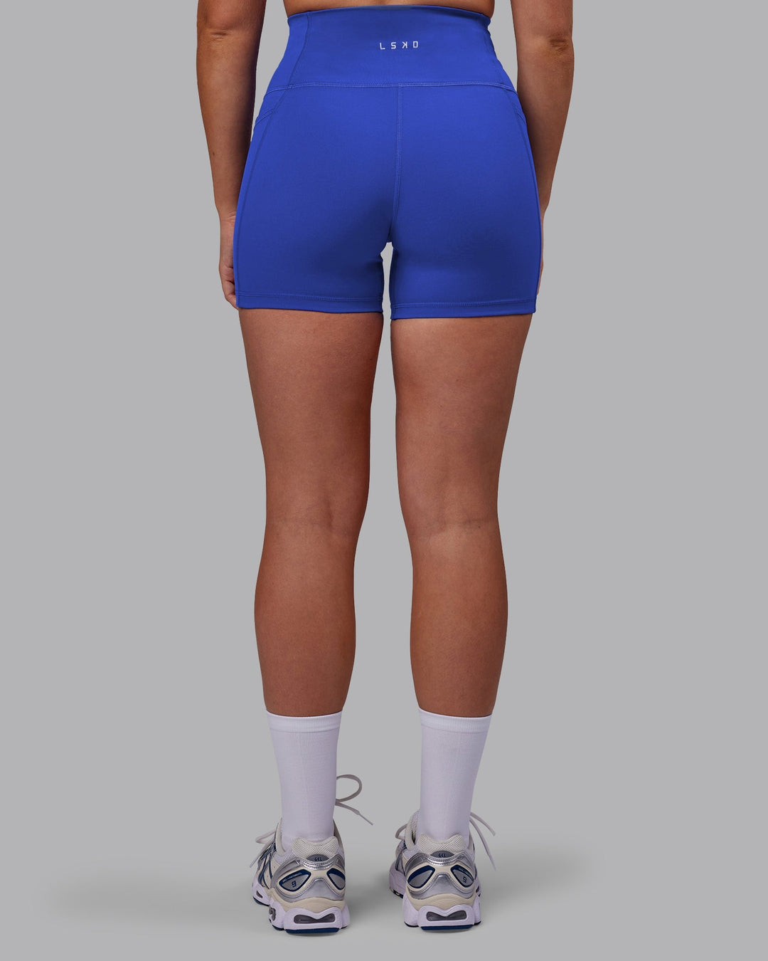 Woman wearing Fusion Ultra High-Rise 4" Short Pockets - Power Cobalt | Model:Hannah | Size:S