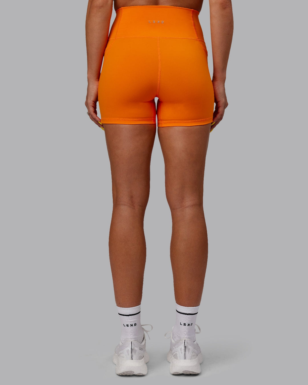 Woman wearing Fusion X-Length Shorts - Vibrant Orange