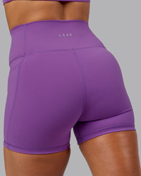 Woman wearing Fusion Ultra High-Rise 4" Short Pockets - Purple Fizz | Model:Shalem | Size:S