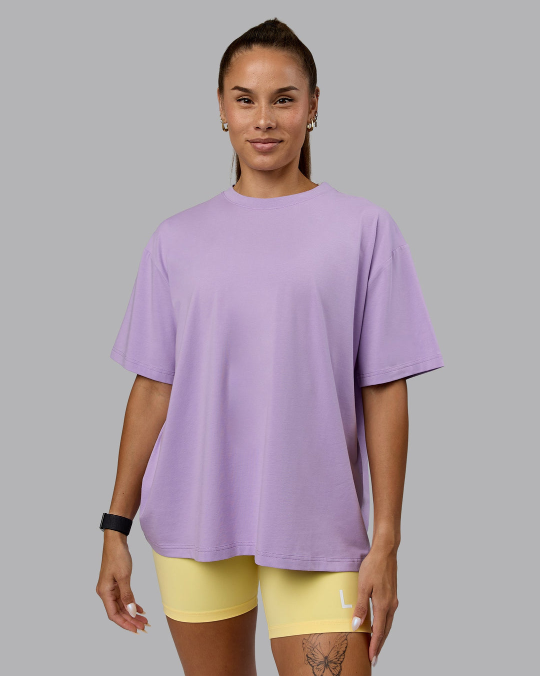 Woman wearing Go-To Set The Standard FLXCotton Oversized Tee - Pale Lilac-Elfin Yellow