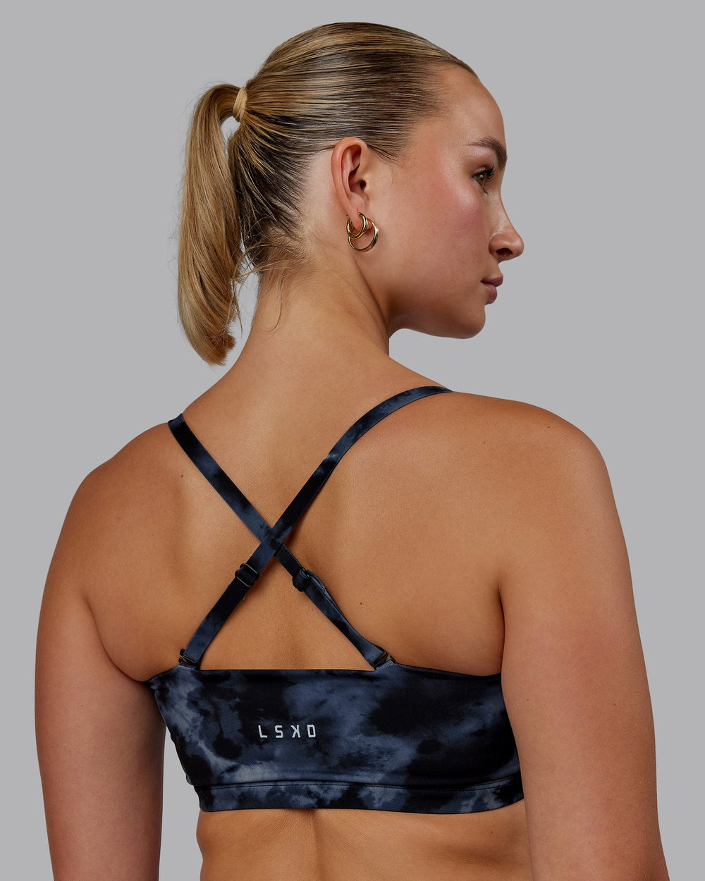 Woman wearing Inspire Sports Bra - Tie Dye-Midnight