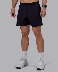 Man wearing Lift 6" Performance Shorts - Black-Reflective