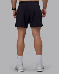 Man wearing Lift 6" Performance Shorts - Black-Reflective
