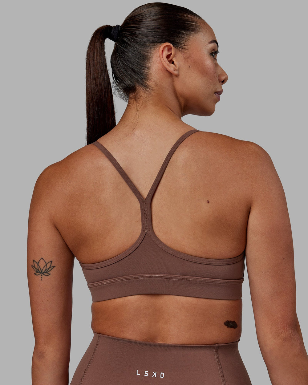 Woman wearing Lift Sports Bra - Dull Rust