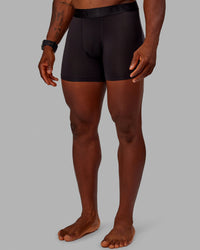 Man wearing MVP Trunks 3 Pack - Black/Cilantro/Midnight Blue