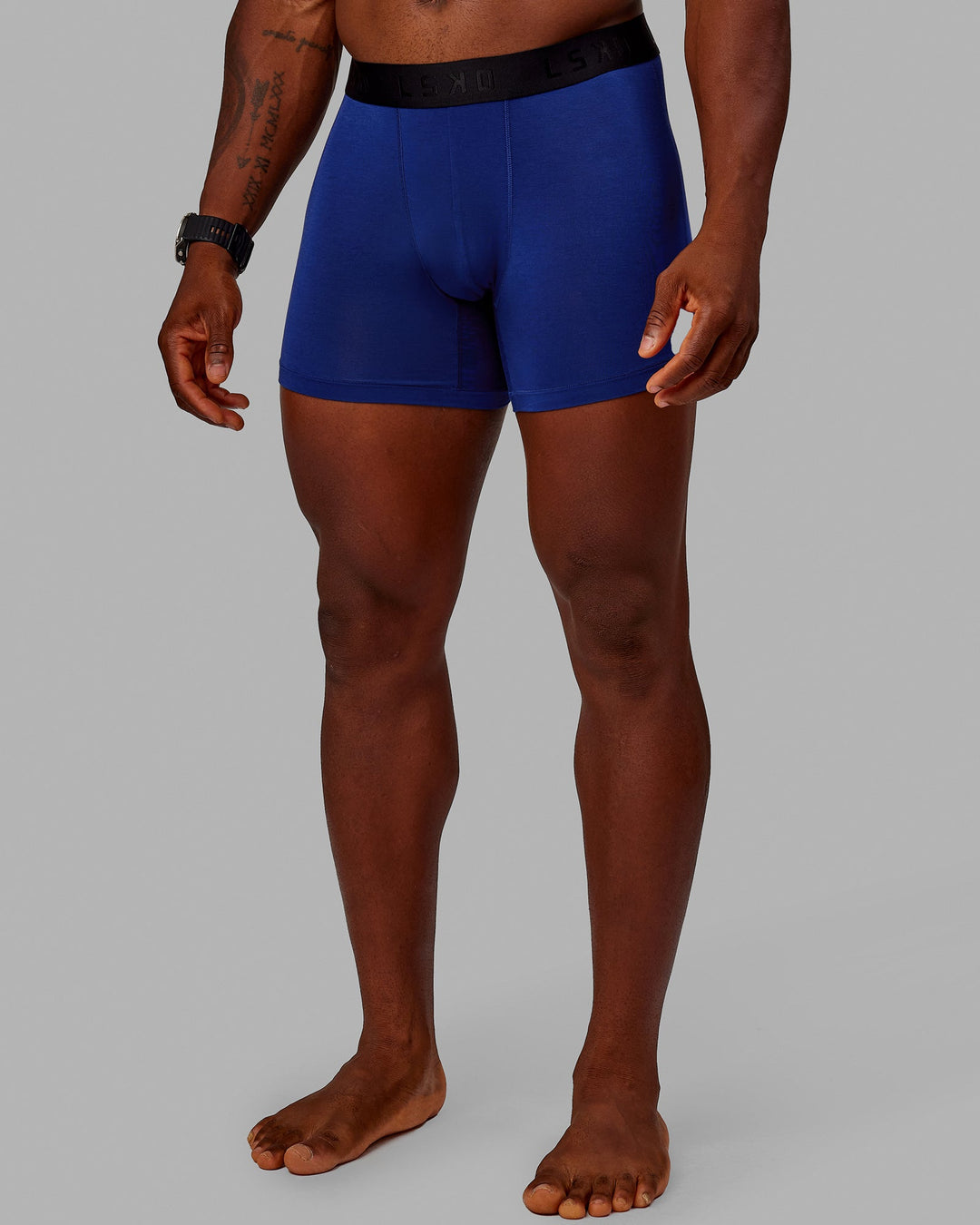 Man wearing MVP Trunks 3 Pack - Black/Cilantro/Midnight Blue