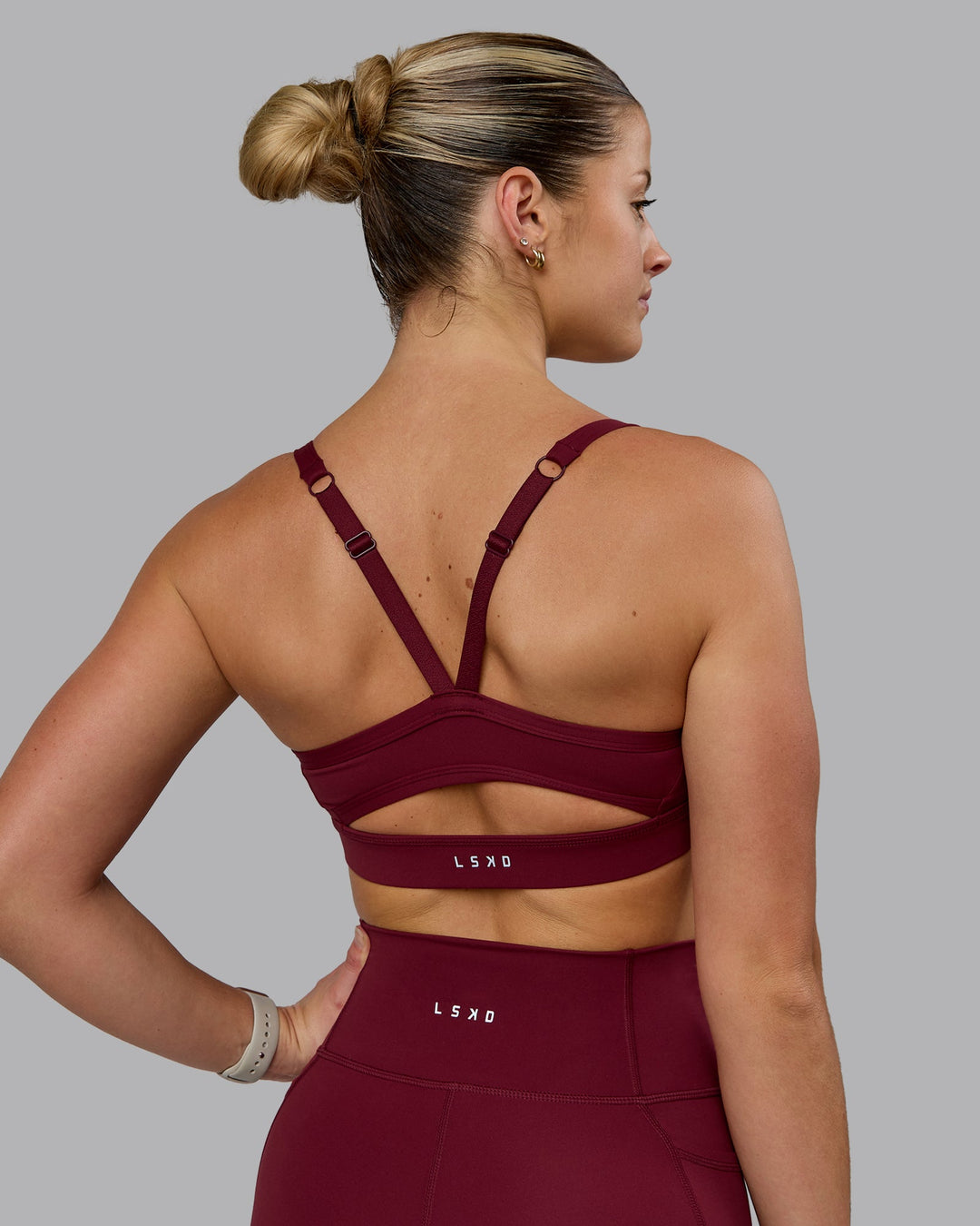 Woman wearing Momentum Sports Bra - Cordovan