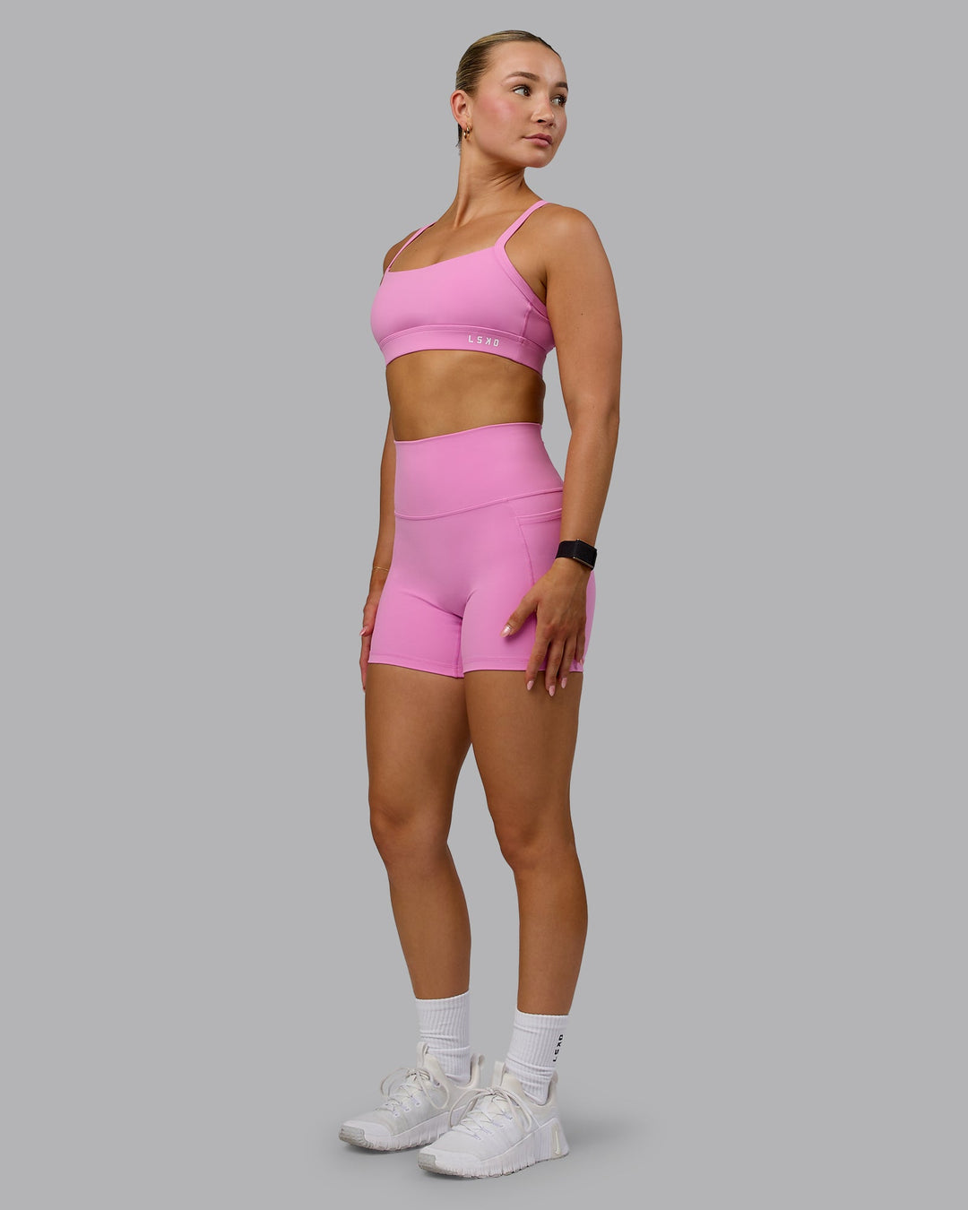 Woman wearing Momentum Sports Bra - Spark Pink