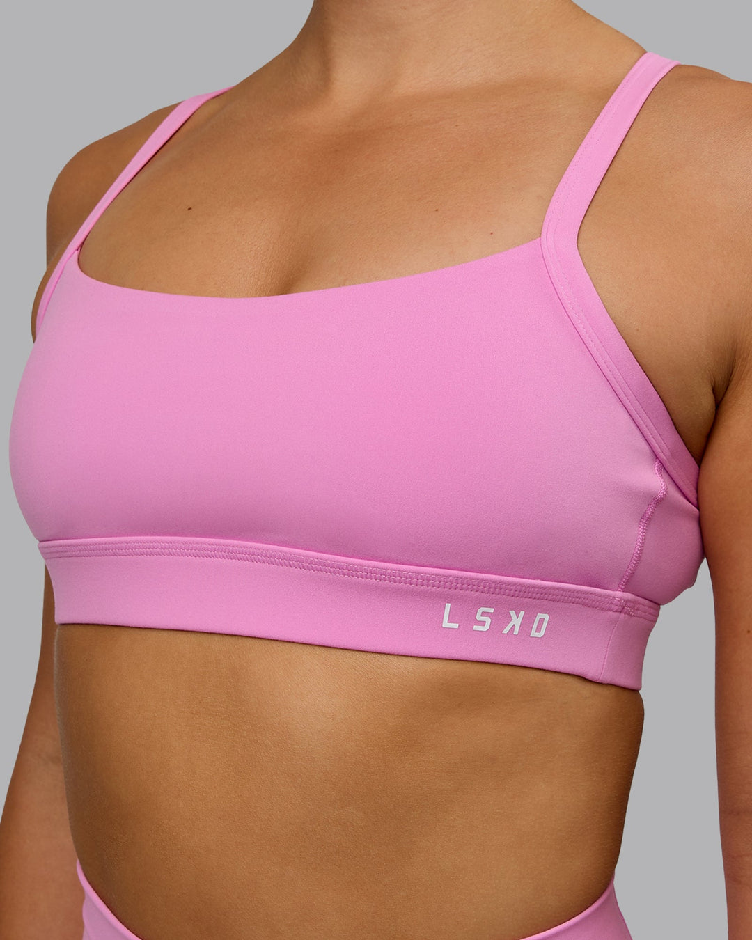 Woman wearing Momentum Sports Bra - Spark Pink