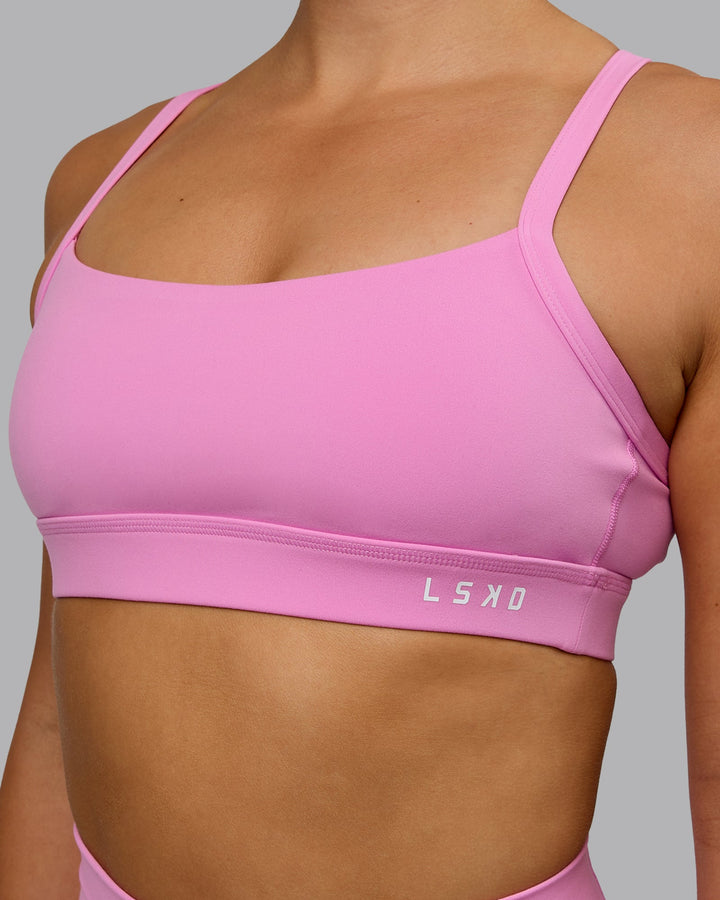 Woman wearing Momentum Sports Bra - Spark Pink
