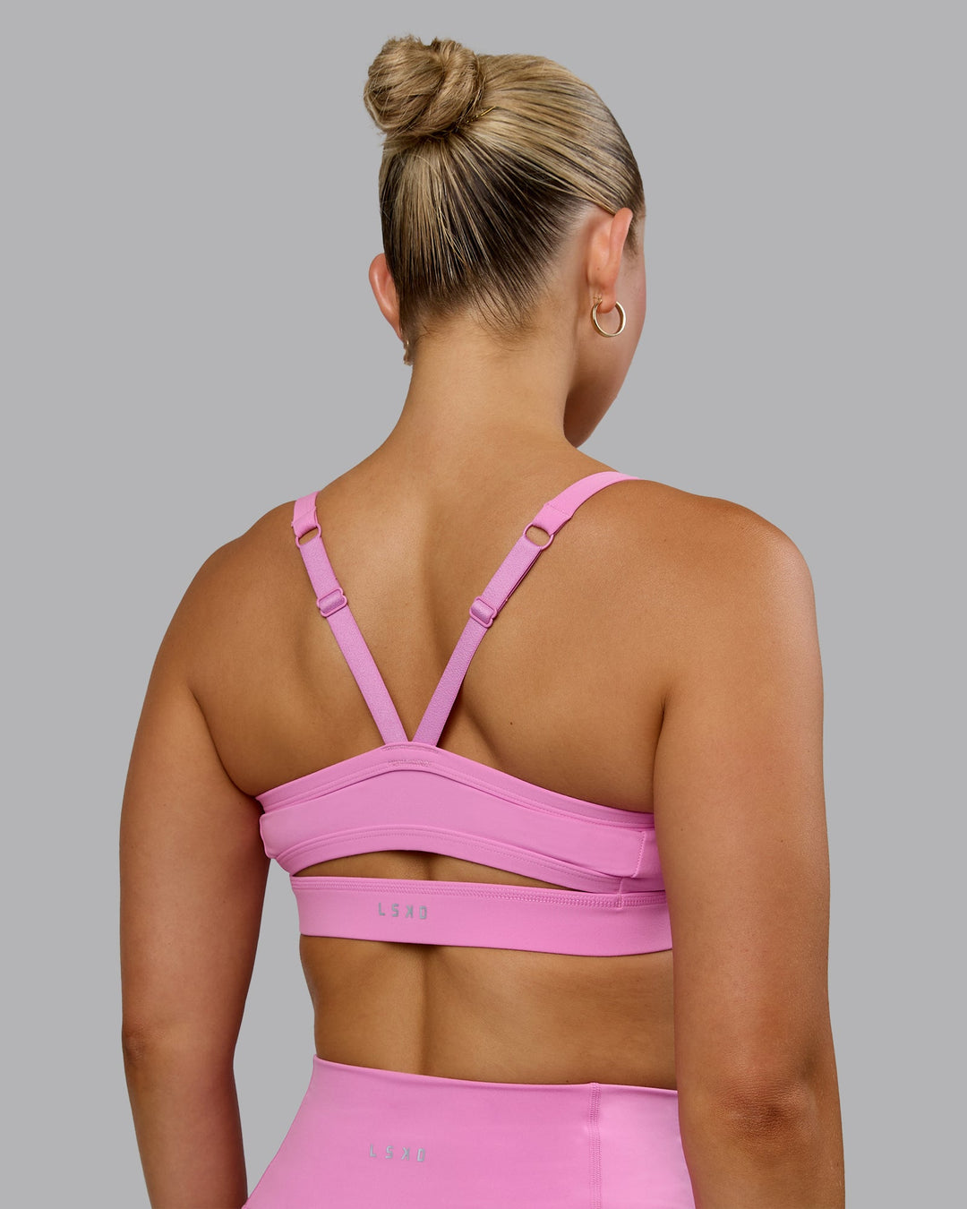 Woman wearing Momentum Sports Bra - Spark Pink