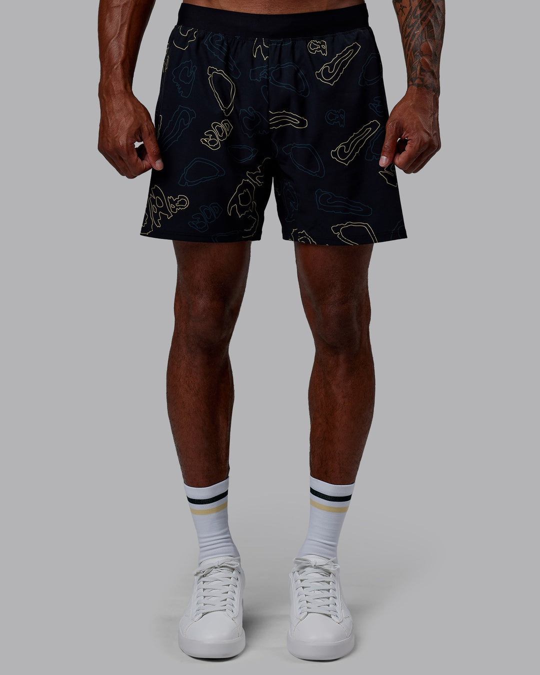 Man wearing Patty Mills Challenger 6&quot; Performance Shorts - Black-Vital Green